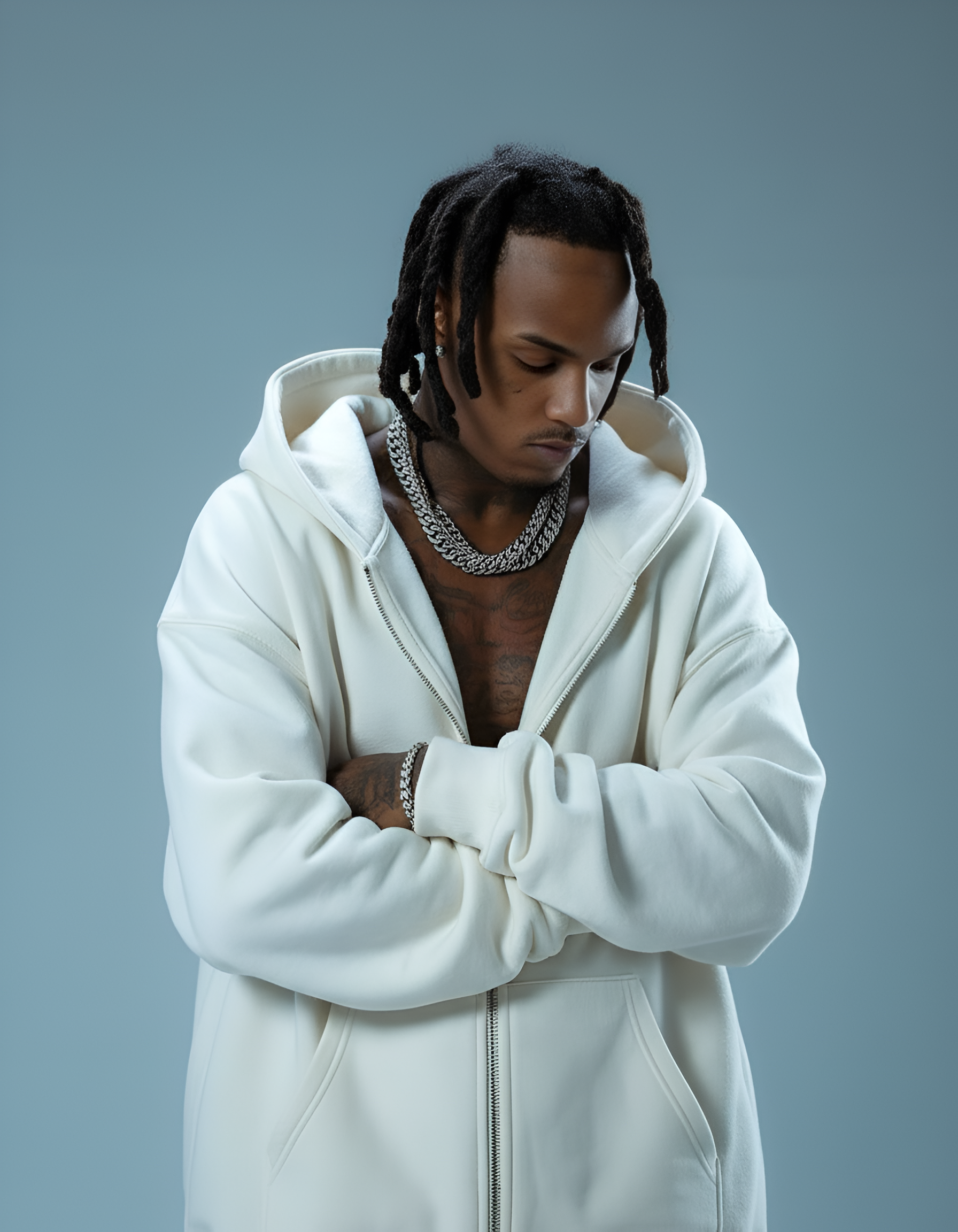 Man wearing a white hoodie against a gray background
